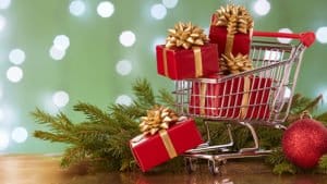 small shopping cart with Christmas presents spilling out